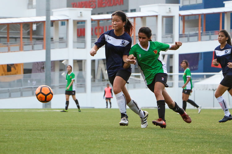 Aileen Rocio Hong (SAJC #14) and Nooriyah Moochhala (RI #7) competing for the ball in midfield. (Photo 1 © Clara Lau/REDintern)