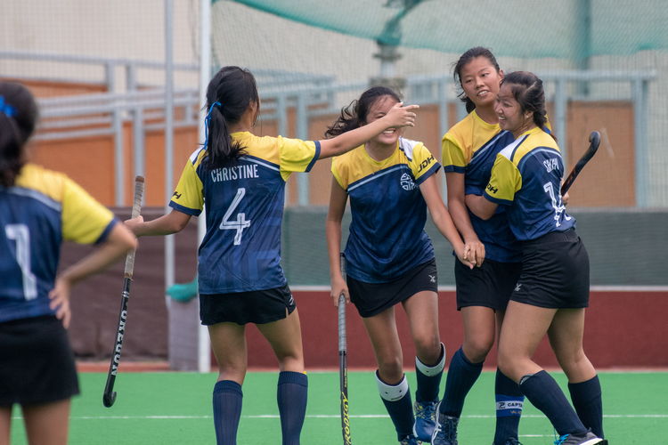 The EJC girls celebrate after captain Valerie Koh's (#17) winning penalty goal.