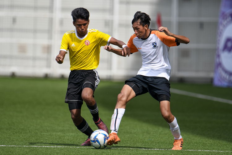 Haikel B Zaini (VJC #11) dribbles up the left flank. Naden Joshua Timothy Koh (SAJC #10) inserts his foot into the ball's path to tackle him.