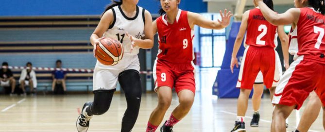 Yeo Ding Xin (NYJC #11) tries to shield the ball from Joanna Wei (NJC #9) as she dribbles the ball down the court. (Photo 2 © Clara Lau/Red Sports)