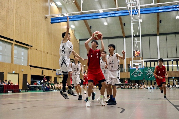 Jayson Tan (DSS #7) in action against defenders of Catholic High.