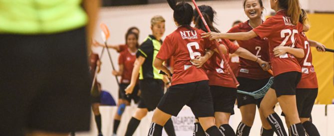 NTU players celebrating their opening goal against RP. Nanyang Technological University completed their Institute-Varsity-Polytechnic (IVP) floorball season in a close-to-perfect run against Republic Polytechnic. The girls in red dominated the match with a 2-0 win as they were crowned 2019/20 IVP champions.(Photo 1 © Stefanus Ian/Red Sports)
