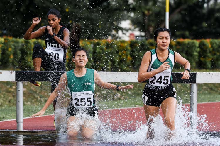 Republic Polytechnic teammates Liew Zhi Shan (#245) and Abby Yap (#255) enter the water jump in the Women's 3000m Steeplechase. (Photo 1 © Iman Hashim/Red Sports)