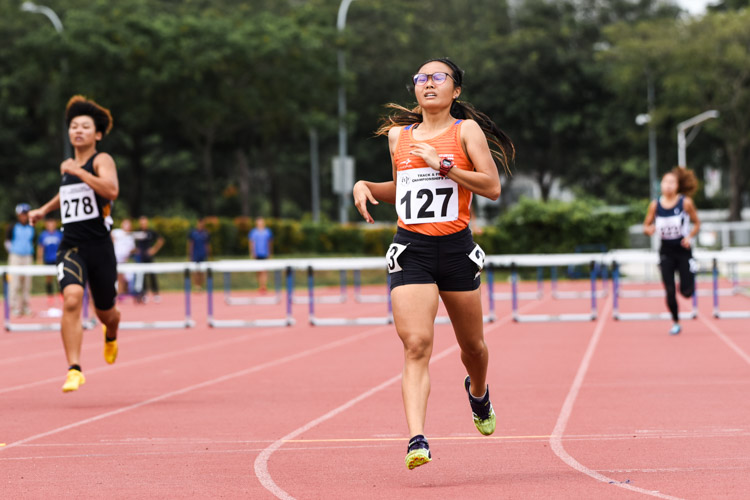 Celeste Goh (#127) of NUS clinched victory in the Women's 400m Hurdles with a time of 1:08.01. (Photo 1 © Iman Hashim/Red Sports)