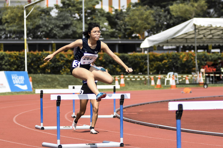 NTU's Clenyce Tan (#199) claimed victory in the women's 400m hurdles timed finals, stopping the clock at 1:08.13. Training partner Nicole Lim (#100) of NUS recorded 1:13.27 to take the silver, while Sim Jia Ying (#61) of SUSS finished with the bronze in 1:20.53. This gold was one of four medals that Clenyce garnered during the meet, with silver medals in the 100m hurdles and 4x400m relay as well as a bronze in the flat 400m. (Photo 90 © Iman Hashim/Red Sports)