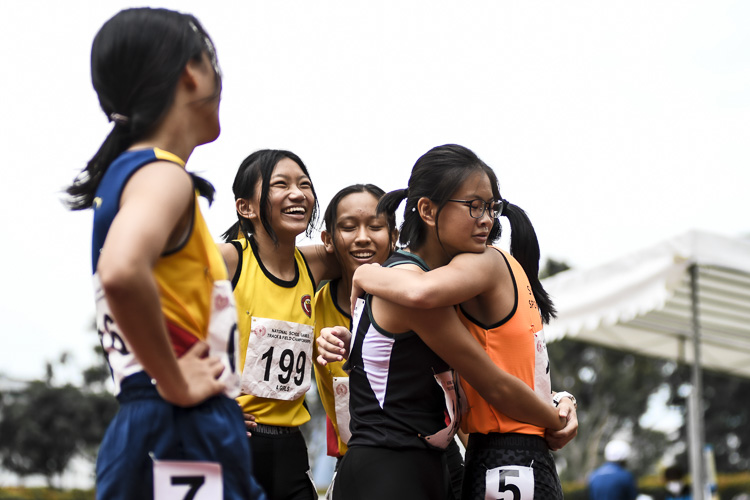 Competitors embrace after the A Div girls' 200m final. (Photo 1 © Iman Hashim/Red Sports)