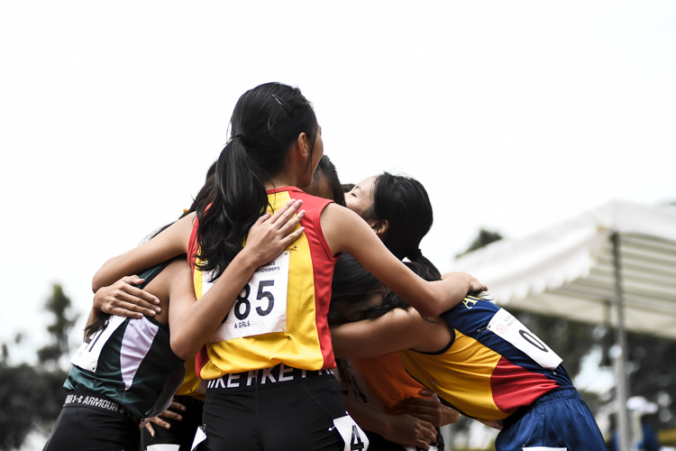 Competitors embrace after the A Div girls' 200m final. (Photo 1 © Iman Hashim/Red Sports)