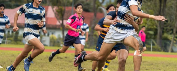 St Andrew's Gerald Yeo (right) carries the ball past the gain line. Anglo-Chinese School (Barker Road) Sub Team 1 pipped St Andrew’s Secondary Sub Team 1 by one conversion to win by 7-5 in the first of two 7-a-side matches in the 2022 B Division National School Games rugby second semi final.