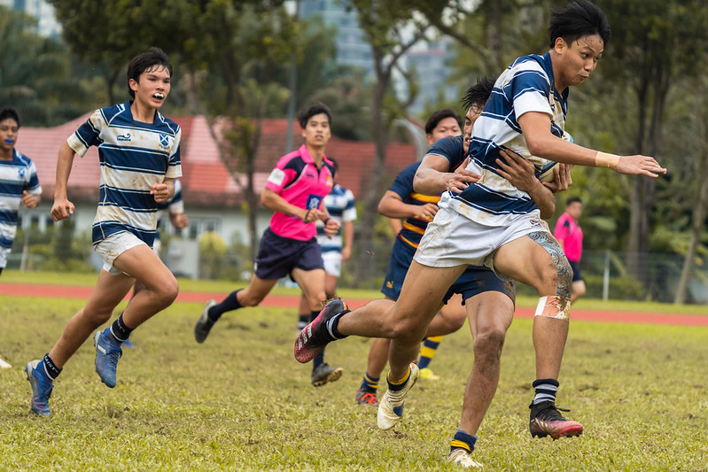 St Andrew's Gerald Yeo (right) carries the ball past the gain line. Anglo-Chinese School (Barker Road) Sub Team 1 pipped St Andrew’s Secondary Sub Team 1 by one conversion to win by 7-5 in the first of two 7-a-side matches in the 2022 B Division National School Games rugby second semi final.
