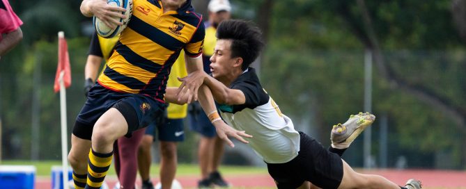 ACS(I)'s Shane O'Hehir (left) broke through the Raffles Institution's defence, as ACS(I) Sub Team 1 beat RI Sub Team 1 38-0 in the 2022 National School Games Rugby Cup semi-final match that spanned three days due to inclement weather.