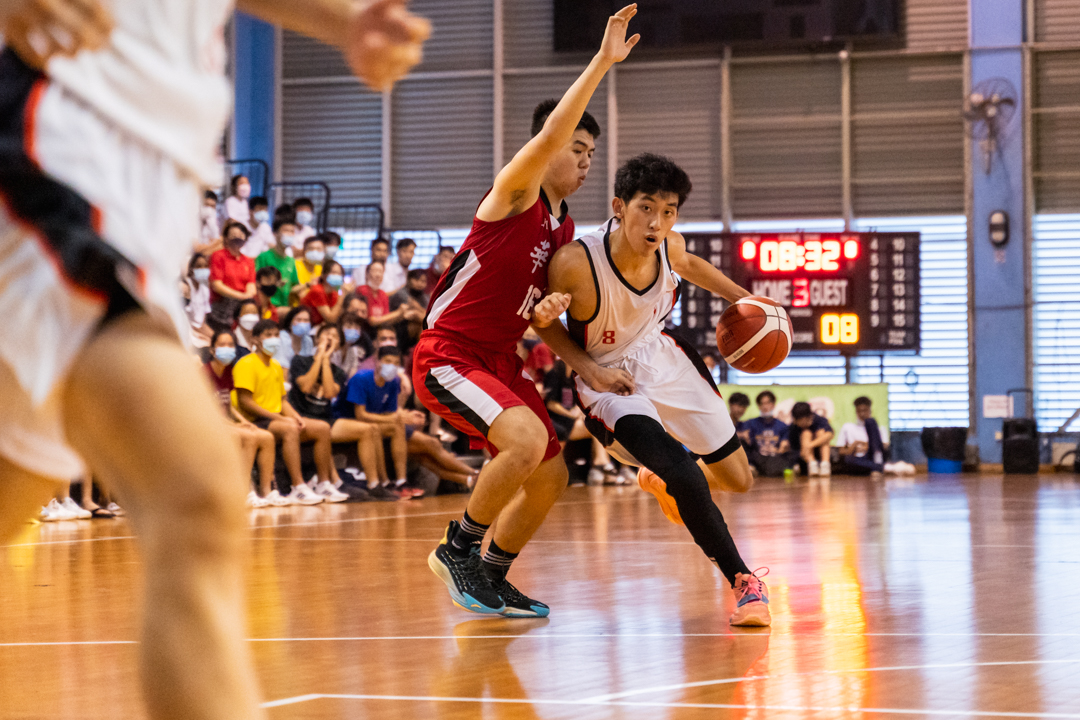 NJC's captain and game MVP Ray Chan (right) fends off the HCI defender. (Photo X © Bryan Foo/Red Sports)