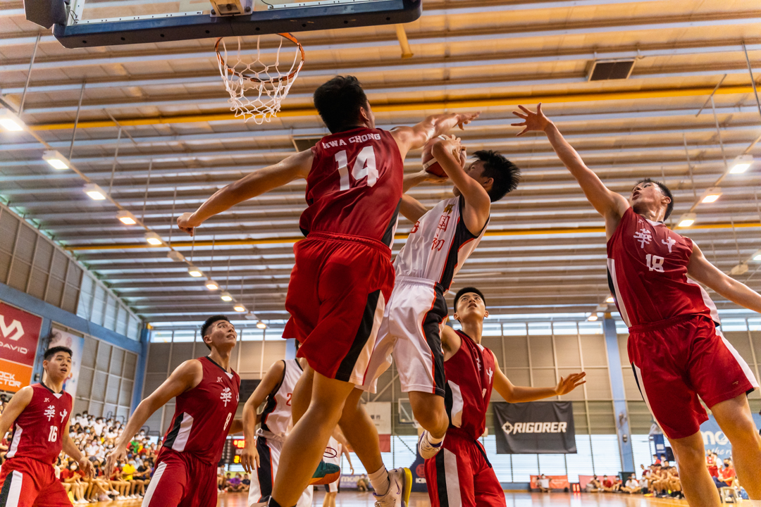 Paolo Lim (centre, in white) attempts to put points on the board for NJC. (Photo X © Bryan Foo/Red Sports)