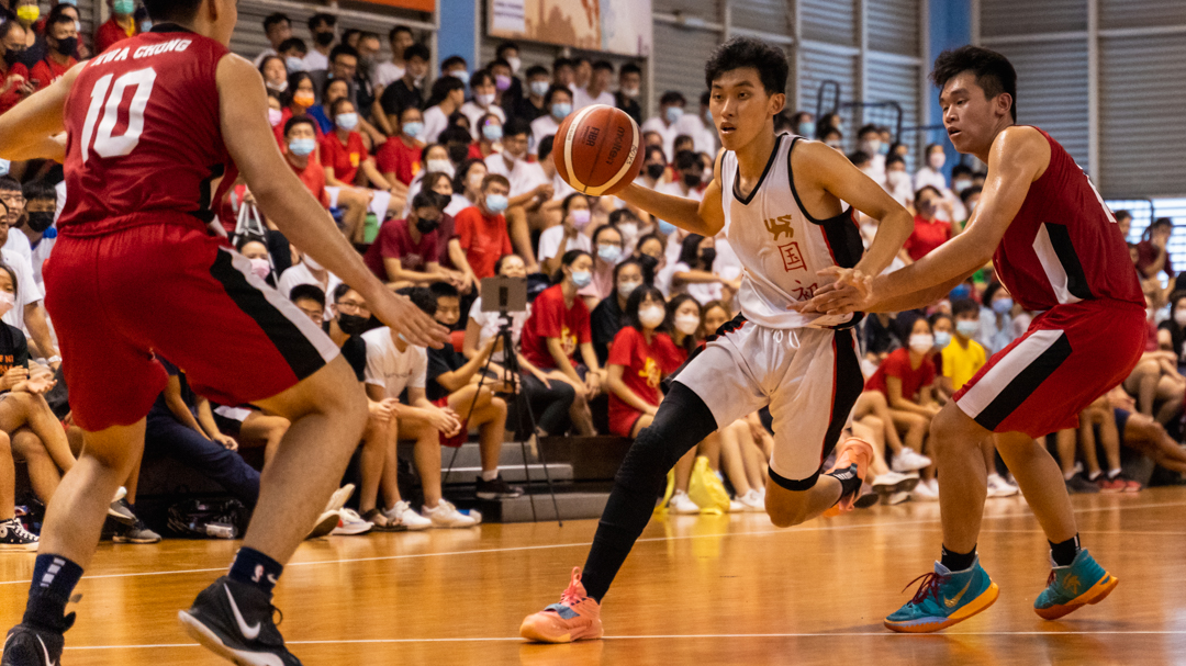 NJC's Ray Chan (centre, in white) tries to make it past the HCI defence. (Photo X © Bryan Foo/Red Sports)