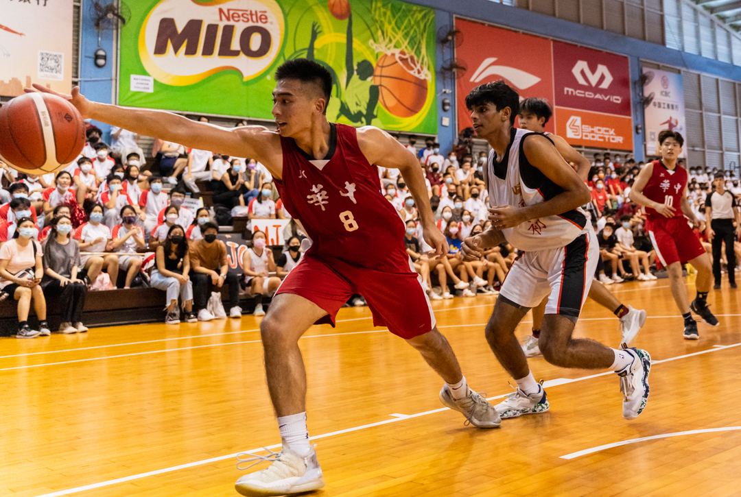 HCI captain Gao Shan (#8) attempts to palm the ball to prevent it from going out of bounds. (Photo X © Bryan Foo/Red Sports)