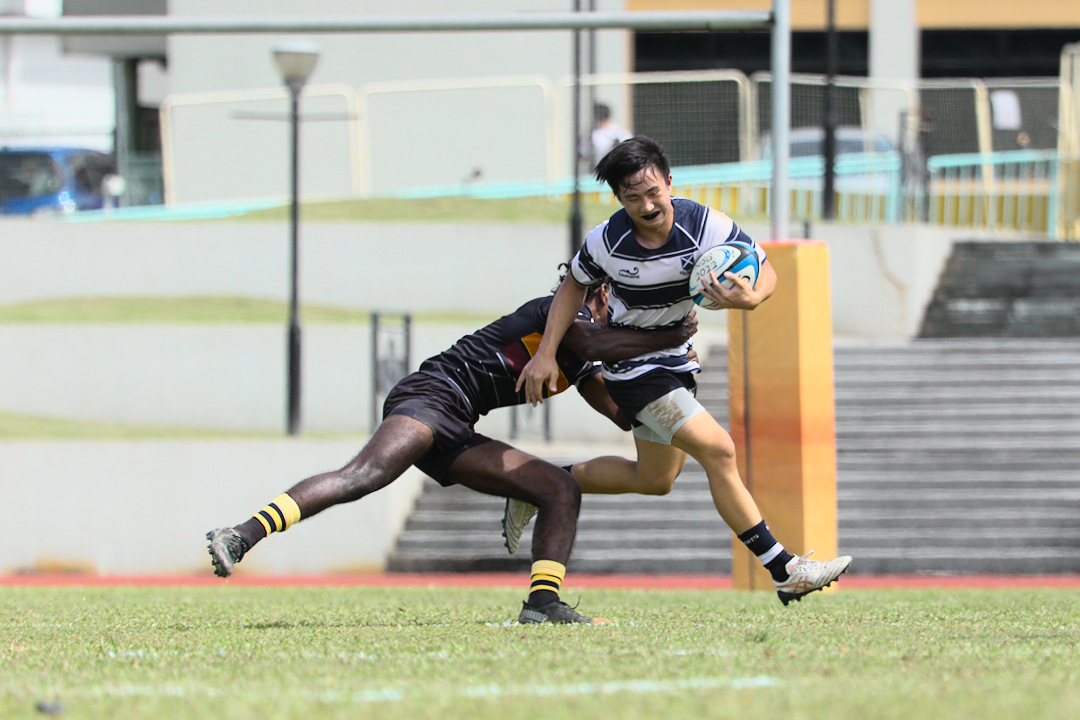 SA's Ian Lee Khang is tackled by Annamalai, who showed a high defensive workmate all game.