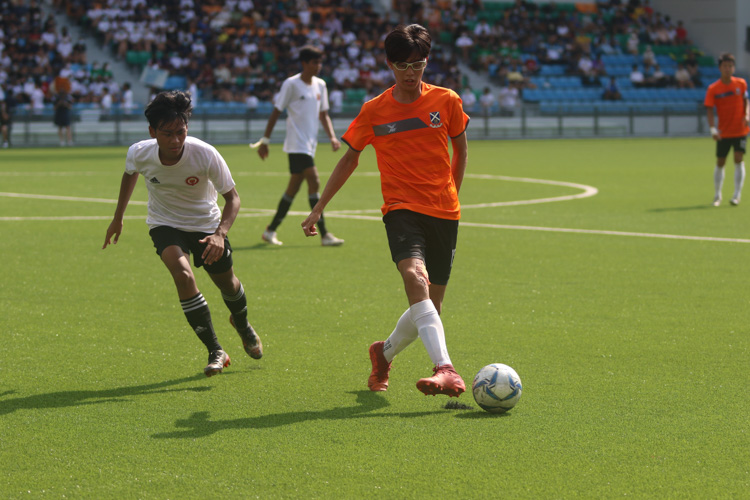 Isaac Lim (SAJC #12) circulates the ball in midfield