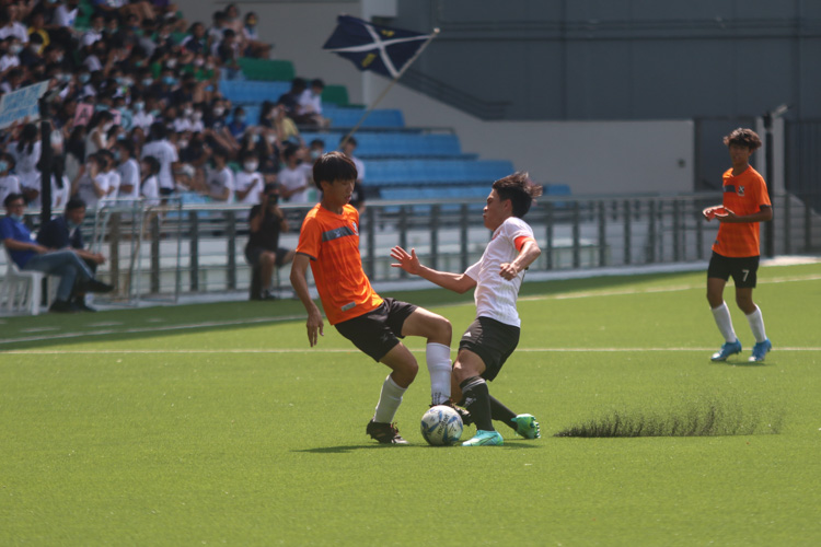 Tan Ray Yien (VJC #12) attempts to steal the ball from Ong E Jay (SAJC #18)