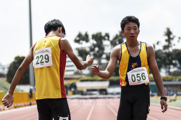 Gold medalist John Tan (#56) of ACS(I) and silver medalist Sun Zizhuo (#229) of HCI share a fist bump are the C Div boys' 200m hurdles final. (Photo 1 © Iman Hashim/Red Sports)