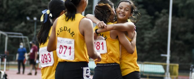 Cedar's Megan Ying, champion in the long jump and silver medalist in the 100m, celebrate with her teammates after winning the B Div girls' 4x100m relay final. (Photo 1 © Iman Hashim/Red Sports)