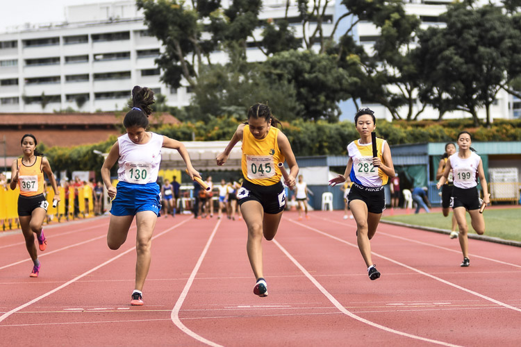 Cedar Girls' Caelyn Chew (#45) anchors her team to gold in the C Div girls' 4x100m relay final in 52.36s, as CHIJ St. Nicholas Girls’ School took the silver and Nanyang Girls' High School the bronze. (Photo 1 © Iman Hashim/Red Sports)