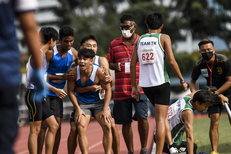 Runners from Maris Stella High mob their anchor runner Ethan Liew (#381) after his run helped them to fourth place in the B Div boys’ 4x400m relay final. (Photo 1 © Iman Hashim/Red Sports)