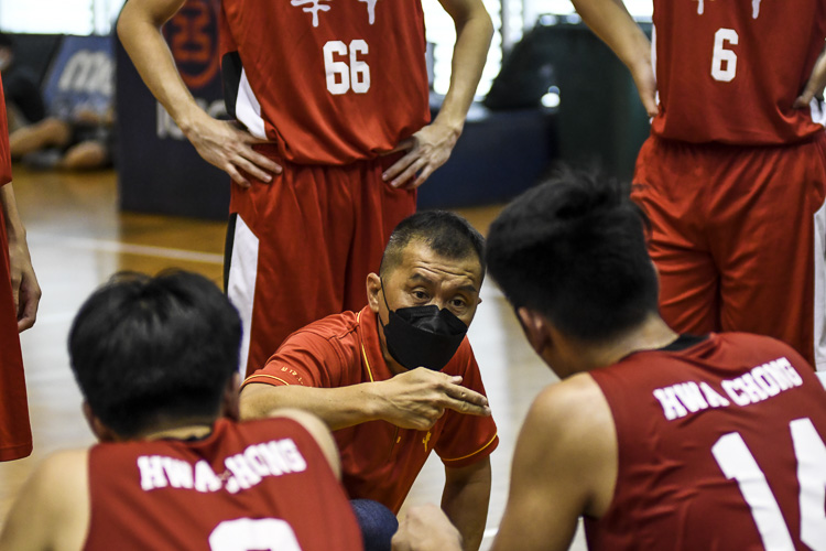HCI take instructions from their coach during a time-out in the last quarter. (Photo 1 © Iman Hashim/Red Sports)