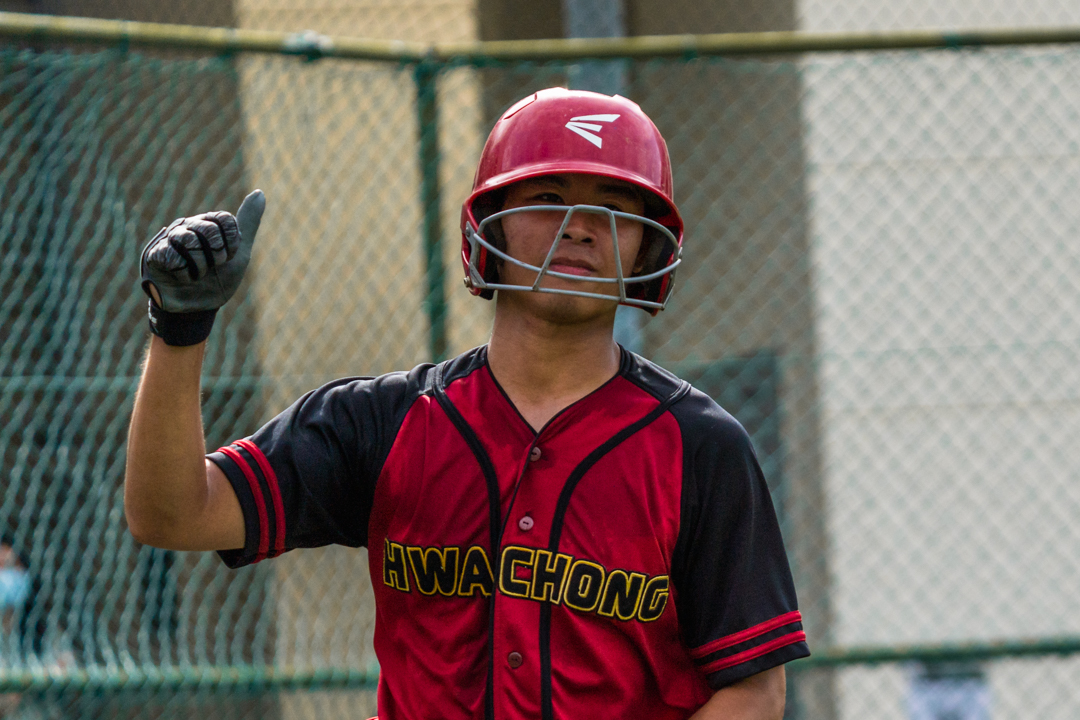 HCI player throws a thumbs-up to his teammates after scoring a run for Hwa Chong. (Photo X © Bryan Foo/Red Sports)