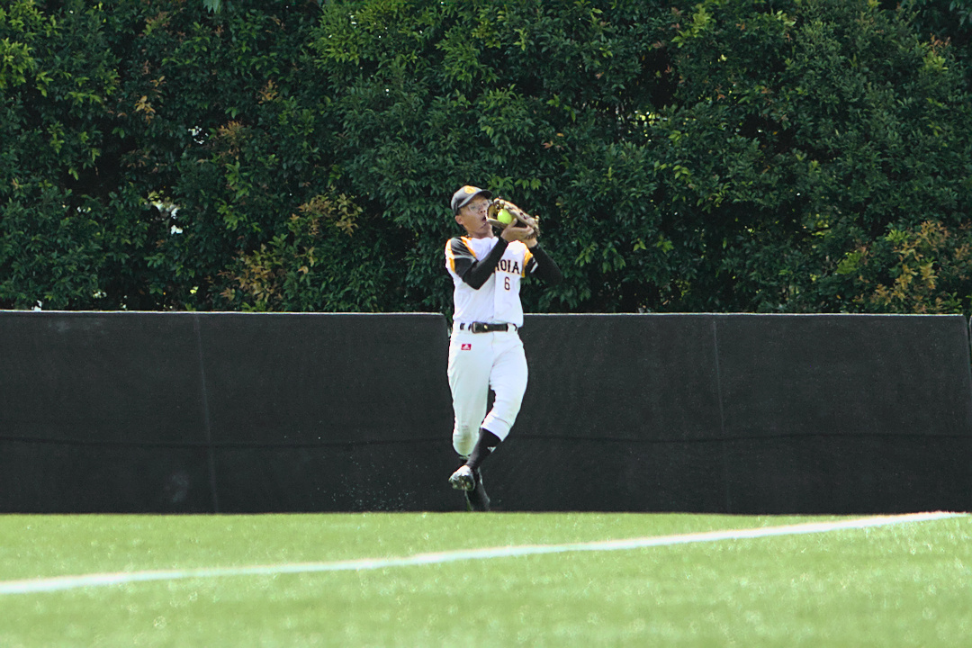 Eunoia fielder Pio Lee (#6) makes the catch in outfield.