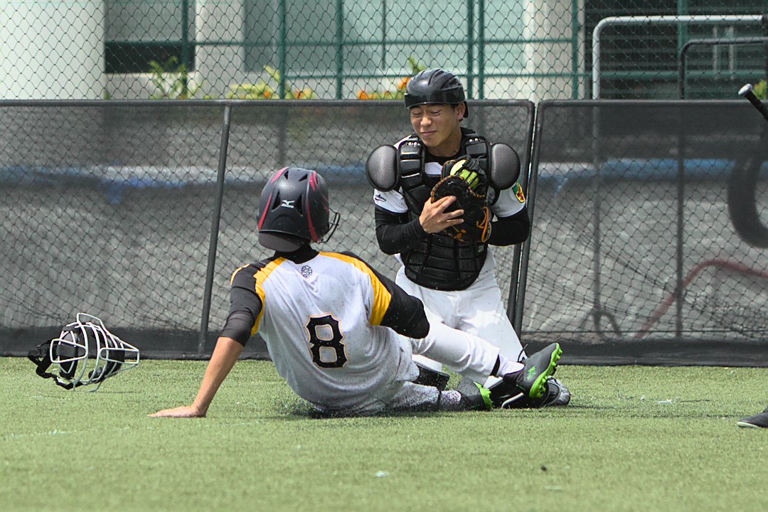 Marvin (#20) receives the ball from teammate Tao (#5) just as Euonia's Gerald Lum (#8) slides in.