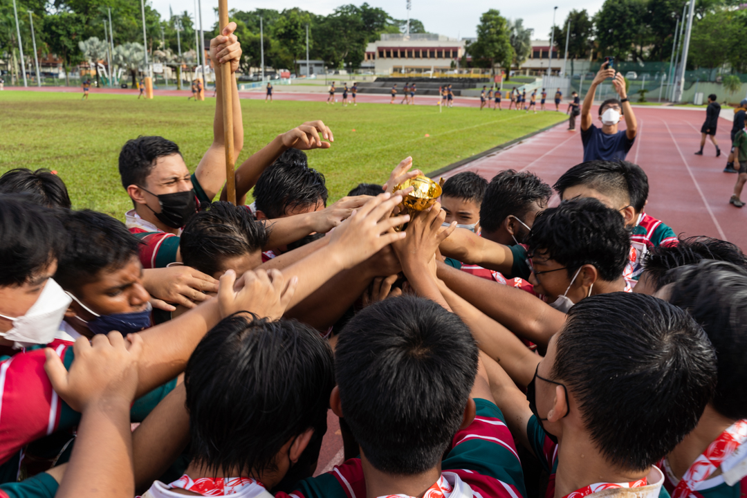 Greenridge Secondary School huddle around their championship trophy to celebrate the win after the final. (Photo X © Bryan Foo/Red Sports)