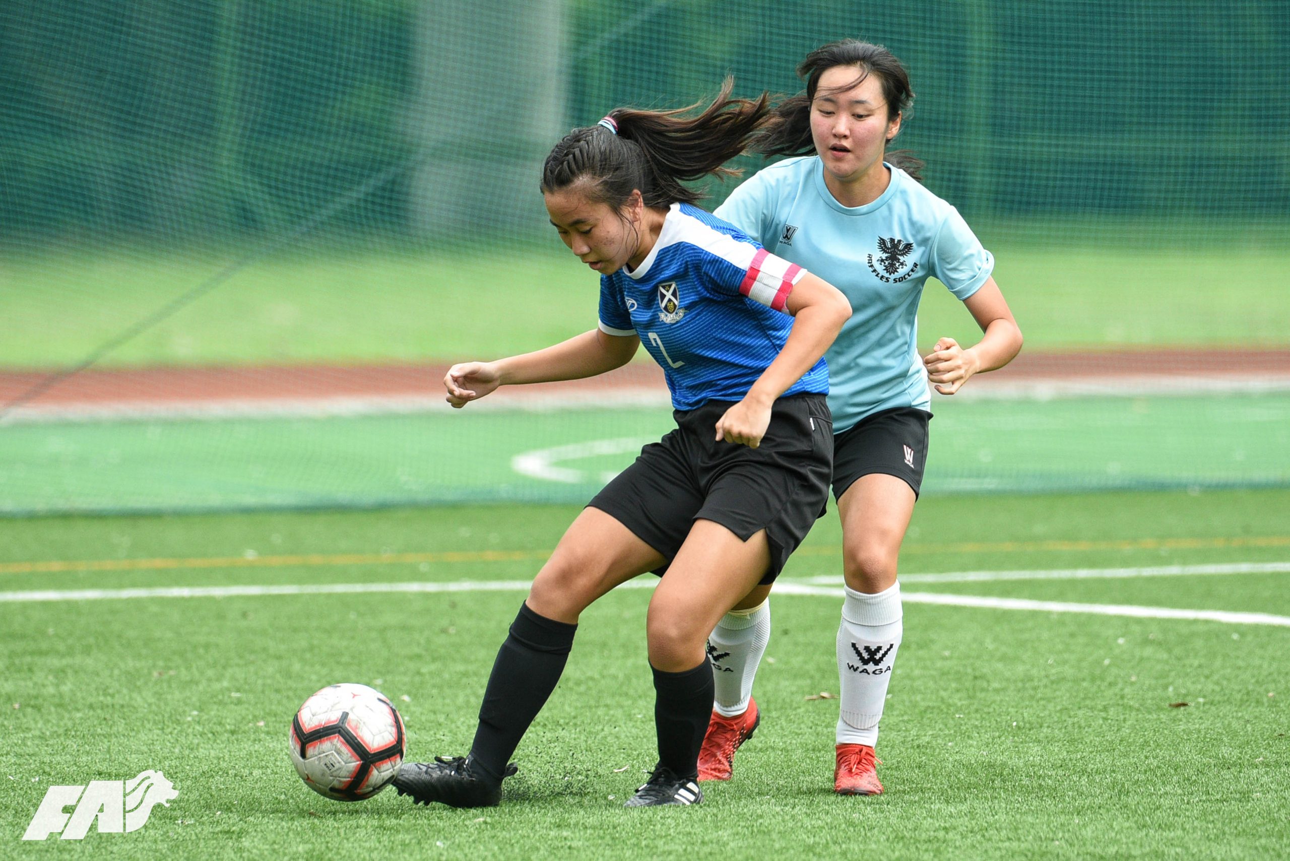 SAJC Captain Chan Kym dribbles during her team's 2-1 defeat of Raffles Institution.