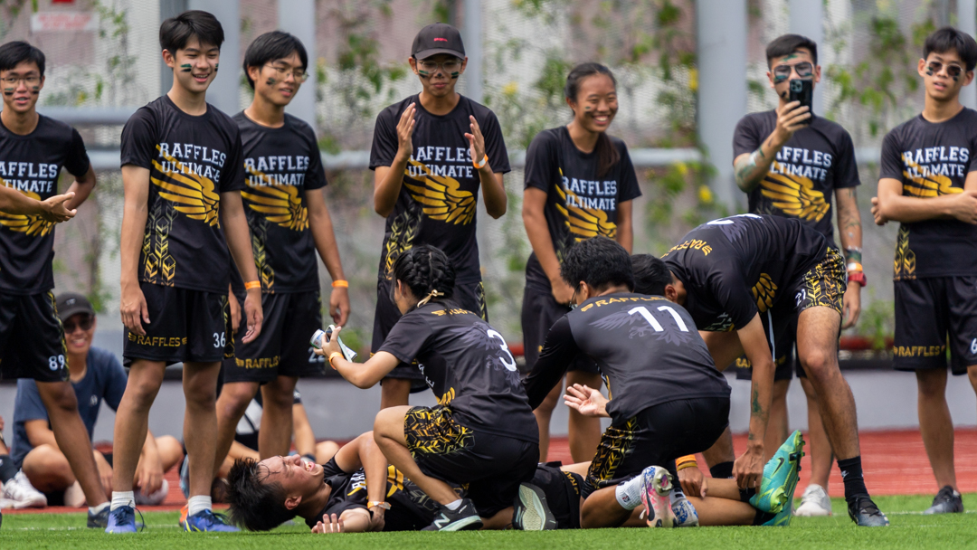 Raffles player being rolled off the field by his teammates after having suffered a double calf cramp.(Photo X © Bryan Foo/Red Sports)
