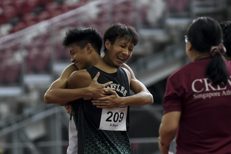 RI's Tate Tan (#238) celebrates with teammate Goh Jaeng Hee (#209) after winning the A Div boys' 100m final. (Photo 1 © Iman Hashim/Red Sports)