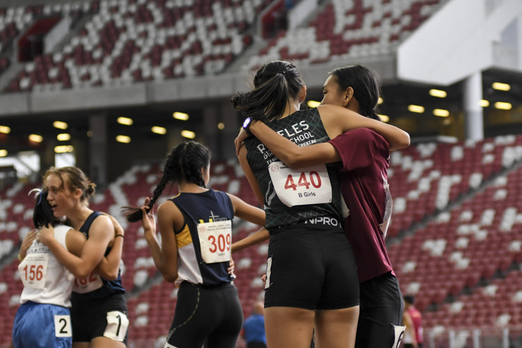 Competitors of the B Div girls' 100m final share a moment after the race. (Photo 1 © Iman Hashim/Red Sports)