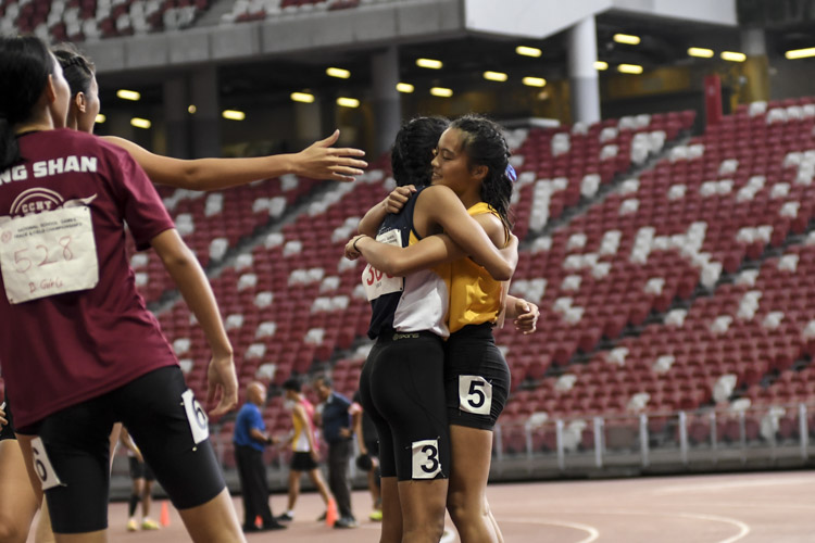 Competitors of the B Div girls' 100m final share a moment after the race. (Photo 1 © Iman Hashim/Red Sports)