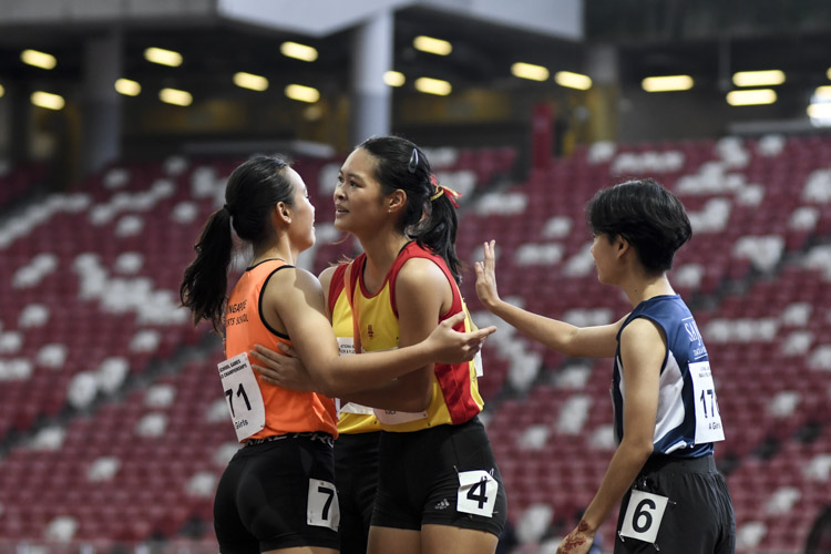 Competitors of the A Div girls' 100m final embrace after the race. (Photo 1 © Iman Hashim/Red Sports)