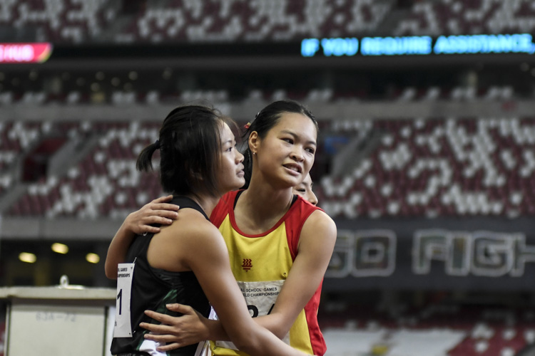 HCI's Eleana Goh and RI's Lyn Liau embrace after the A Div girls' 100m final.. (Photo 1 © Iman Hashim/Red Sports)