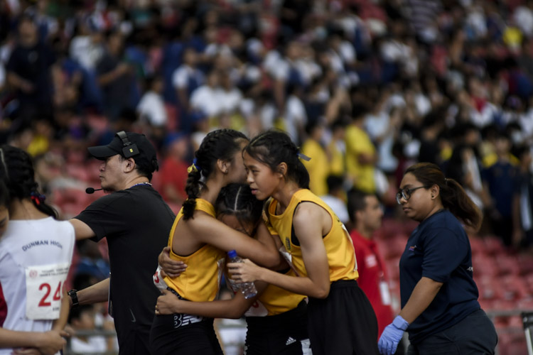 Cedar runners embrace after the B Div girls' 4x400m relay final. (Photo 1 © Iman Hashim/Red Sports)