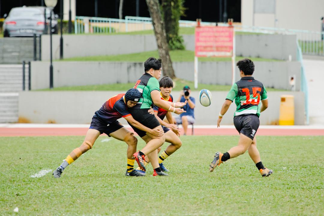 RI's Jayden Tan (#3) passes the ball off to teammate Ernest Yap (#15) (Photo 8 © Shenn Tan/Red Sports)